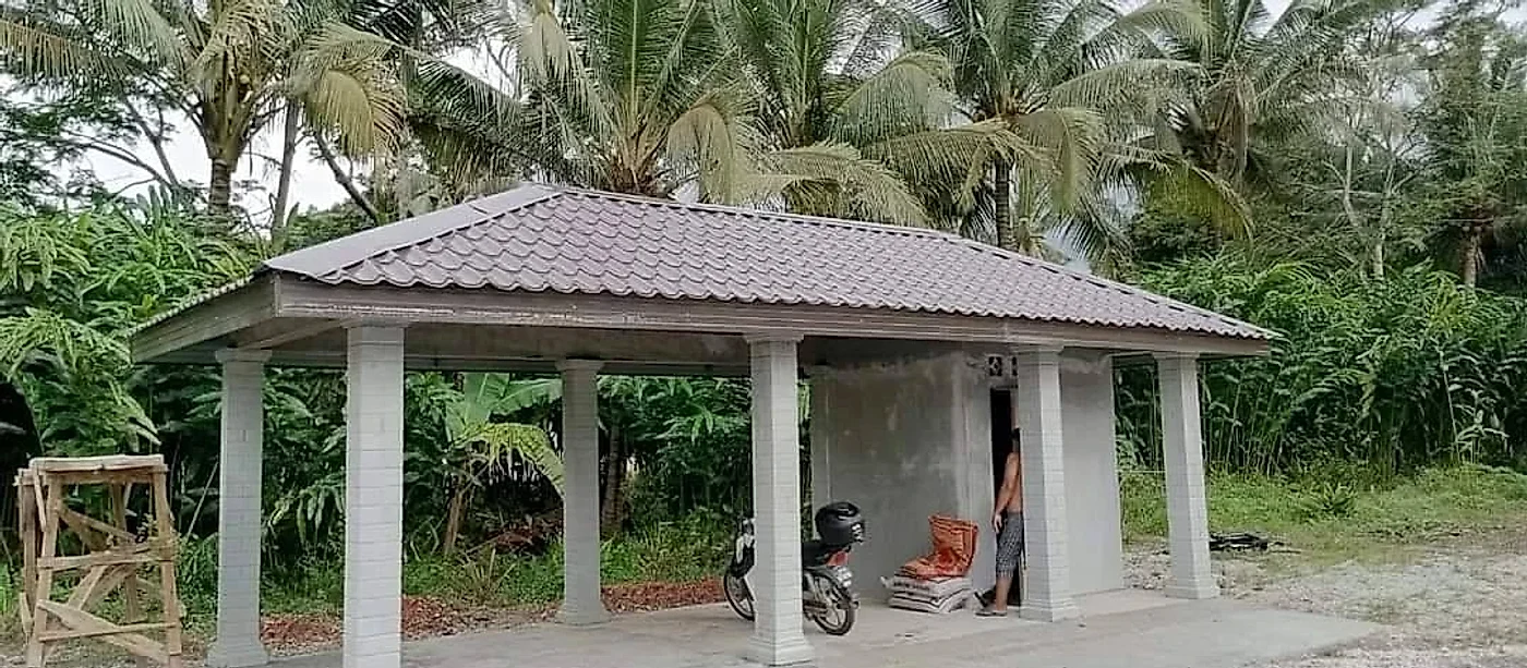 Finished garage with a brown tile-profile metal roof