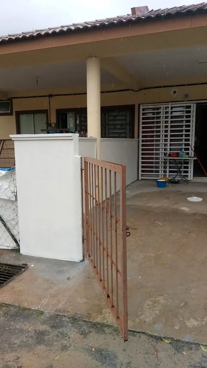 Front gate open beside the finished white fence wall