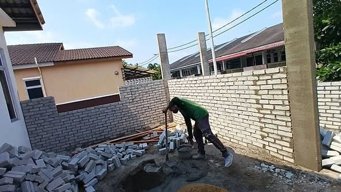 House extension: brick walls going up beside the existing house