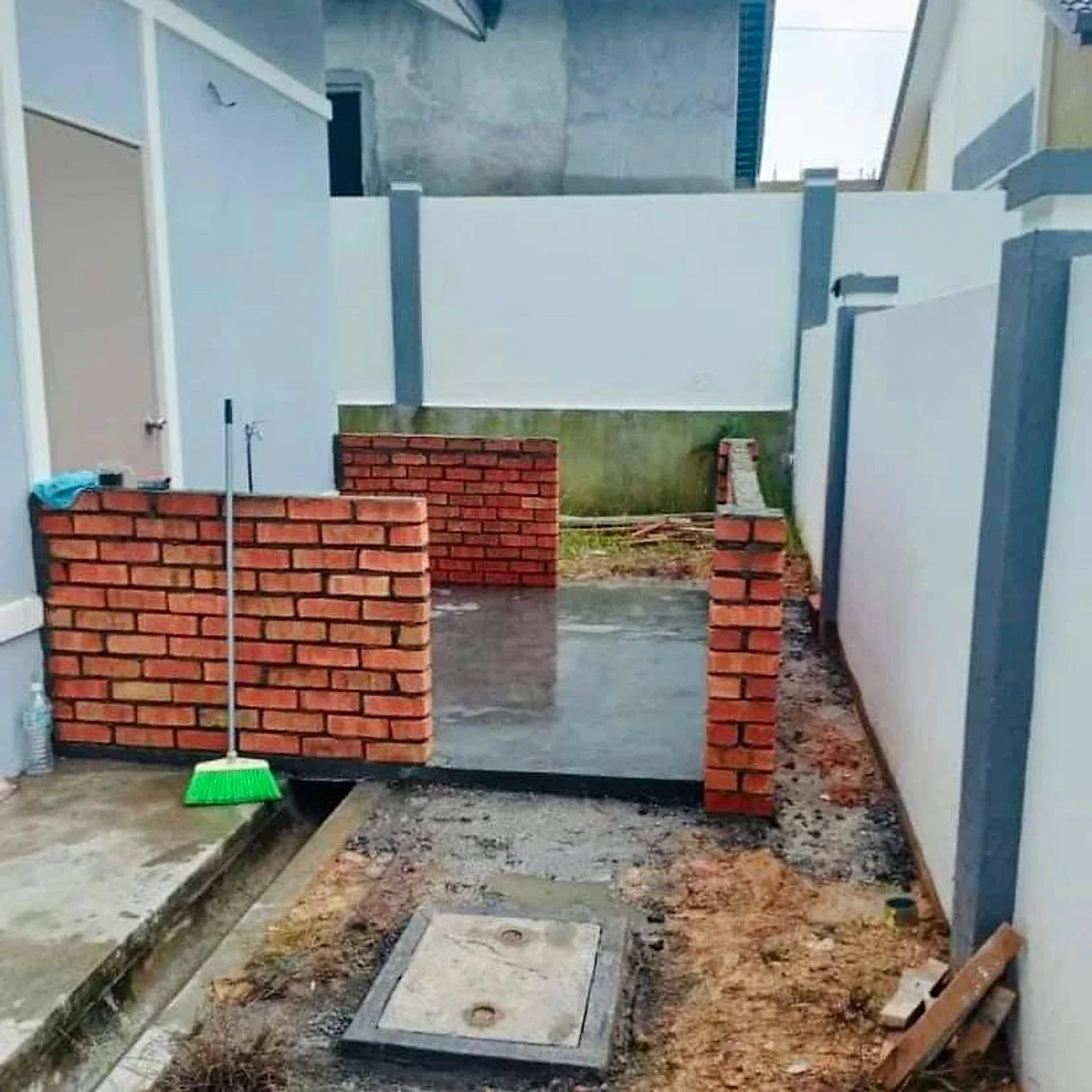 Brick base walls built on a new concrete slab beside the house