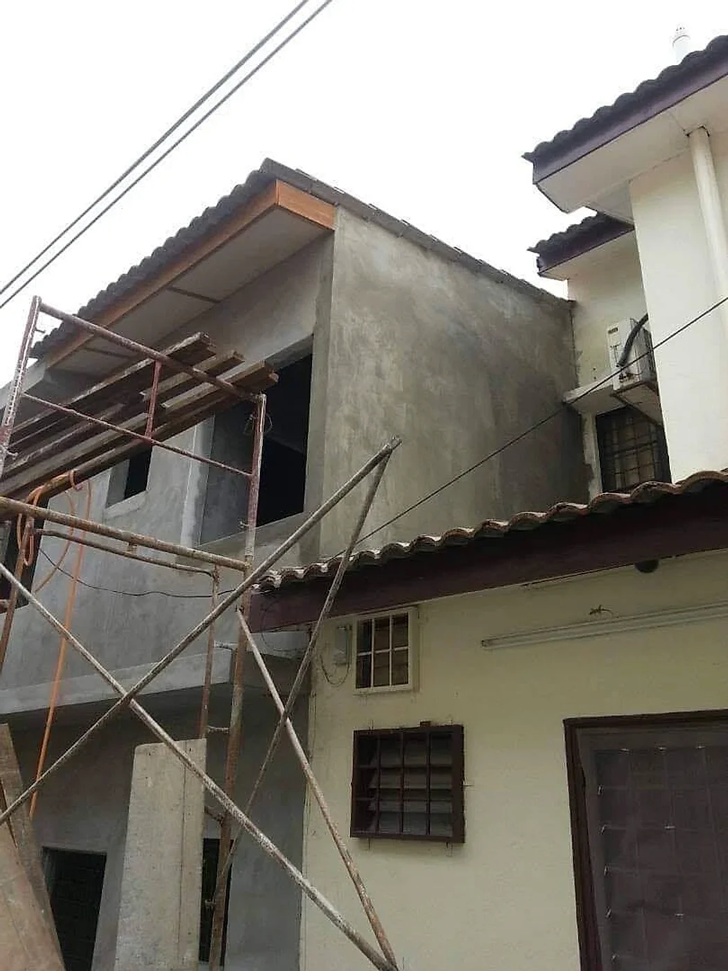 Upper-floor extension plastered and roofed, with scaffolding in front