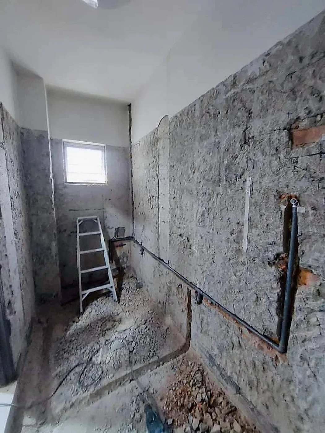 Bathroom stripped back to the wall with new water pipes run