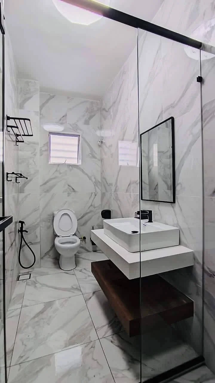 Finished bathroom with a floating vanity, vessel basin, mirror and toilet
