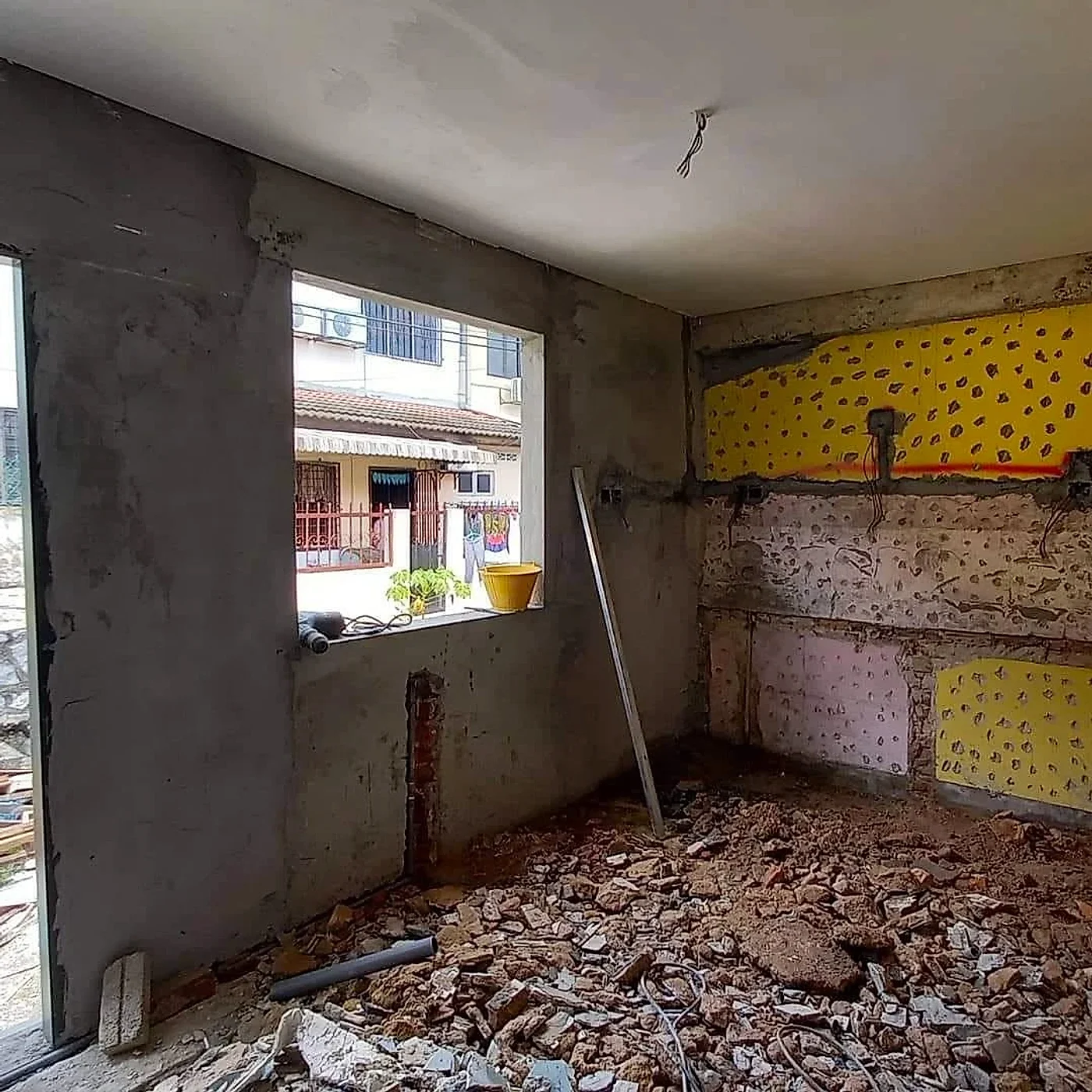 Kitchen stripped back to bare walls with the old tiles removed