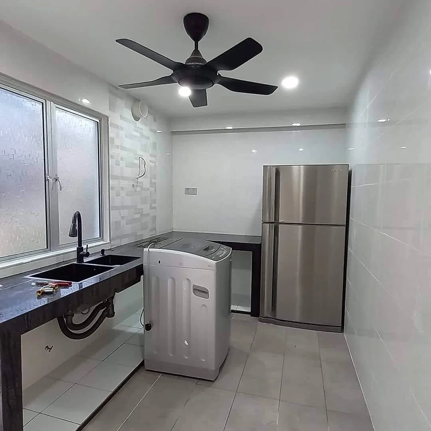 Finished wet kitchen with feature wall tiles, black double sink, ceiling fan and downlights