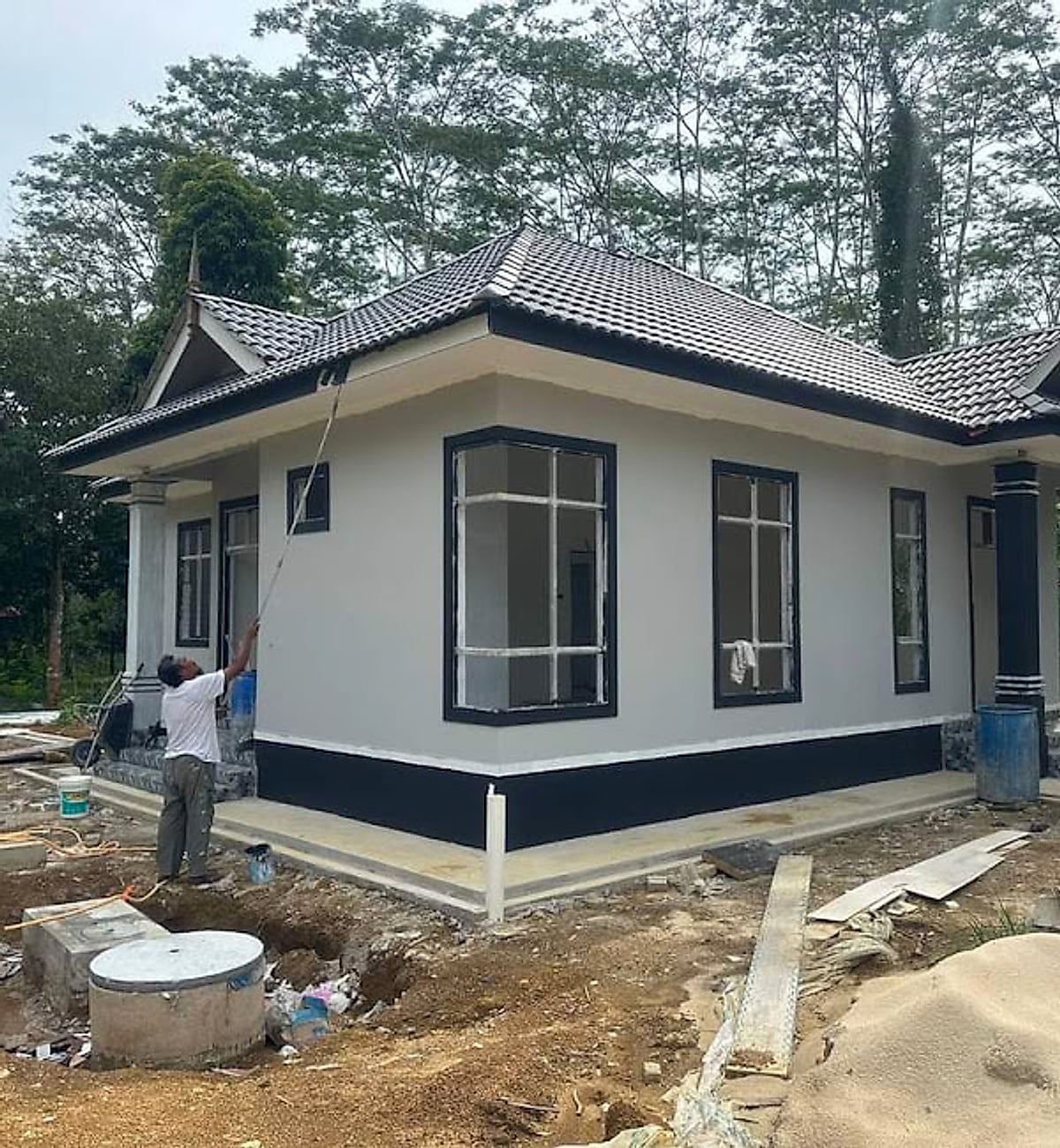 Side elevation of a gabled bungalow with large black-framed windows
