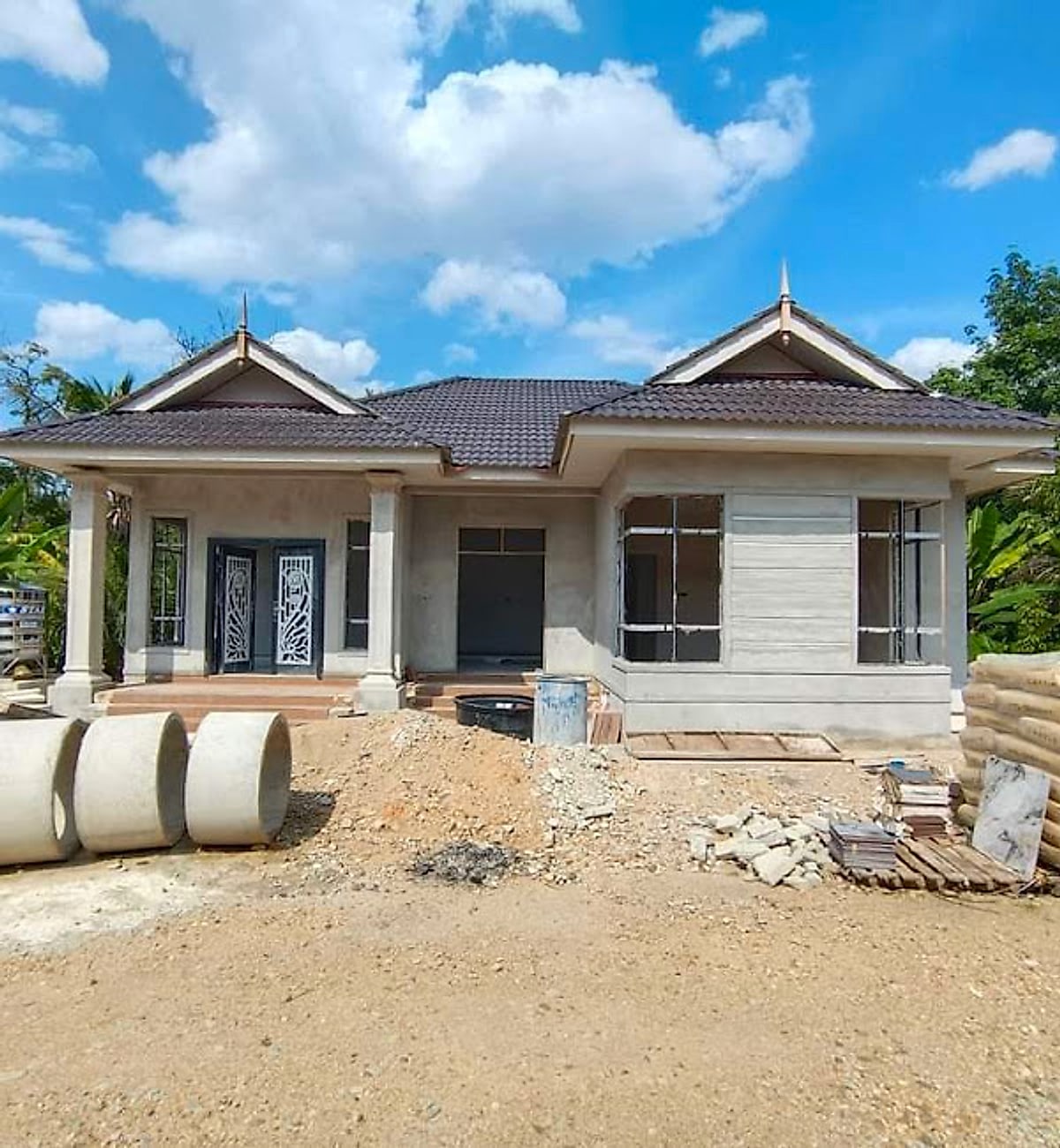 Gabled bungalow under construction with materials on site