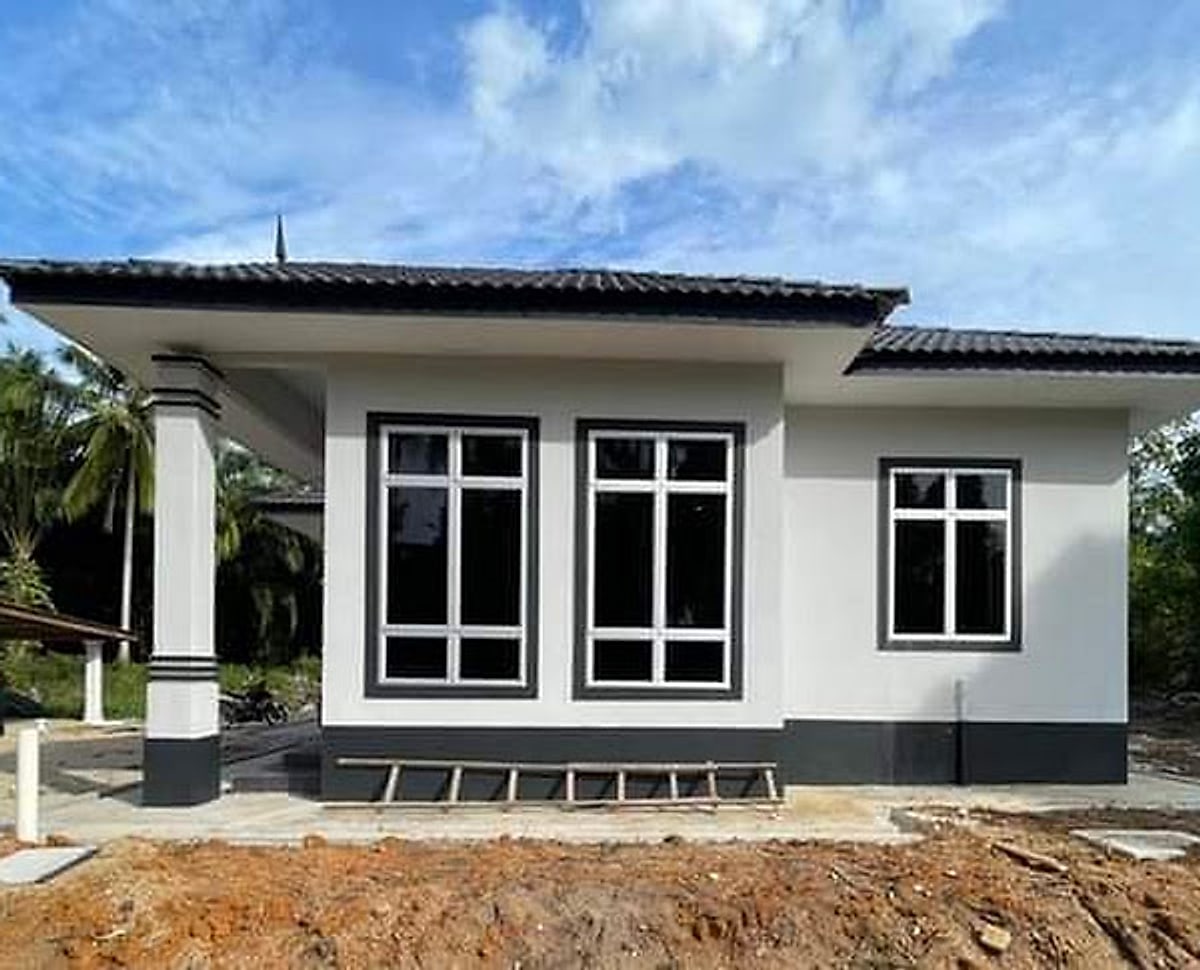 Wing of the bungalow with large black-framed windows