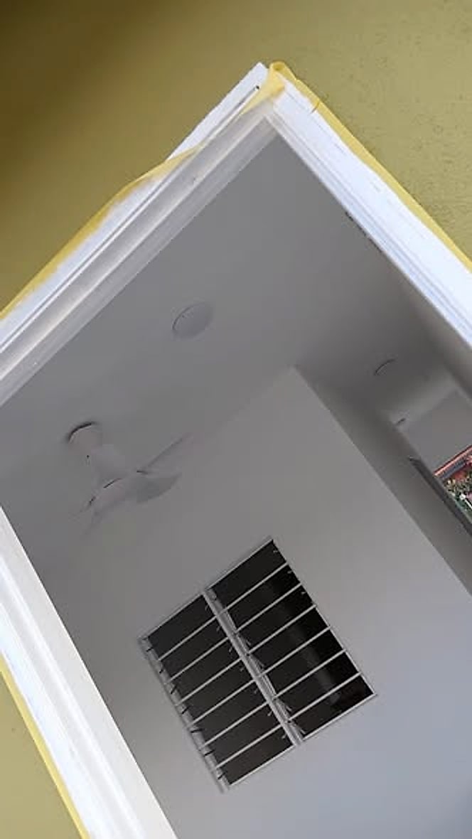 Inside the finished house: white ceiling, fan and downlights