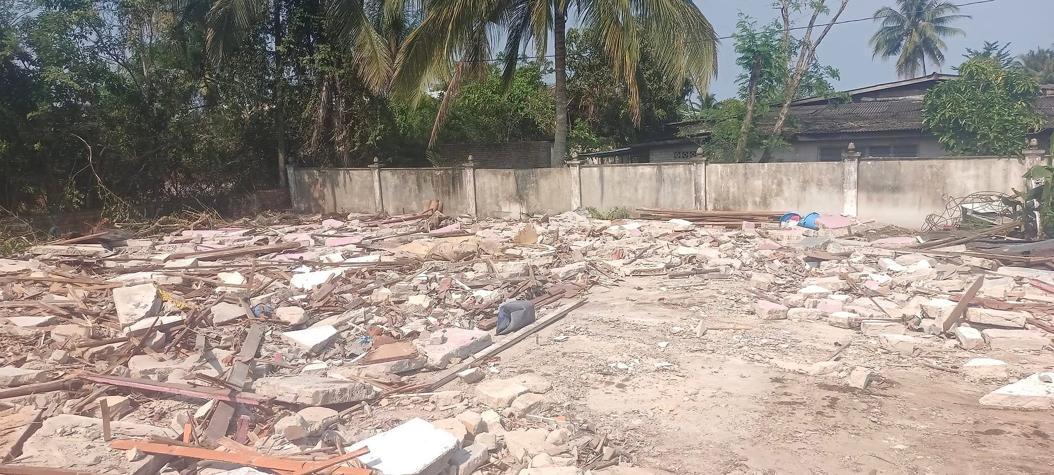 Cleared plot with demolition rubble inside the boundary wall