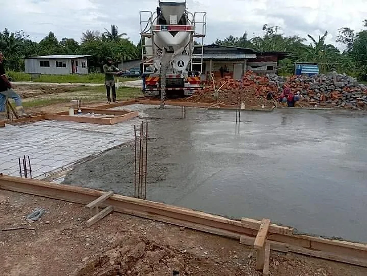 Ready-mix truck pouring the concrete ground slab