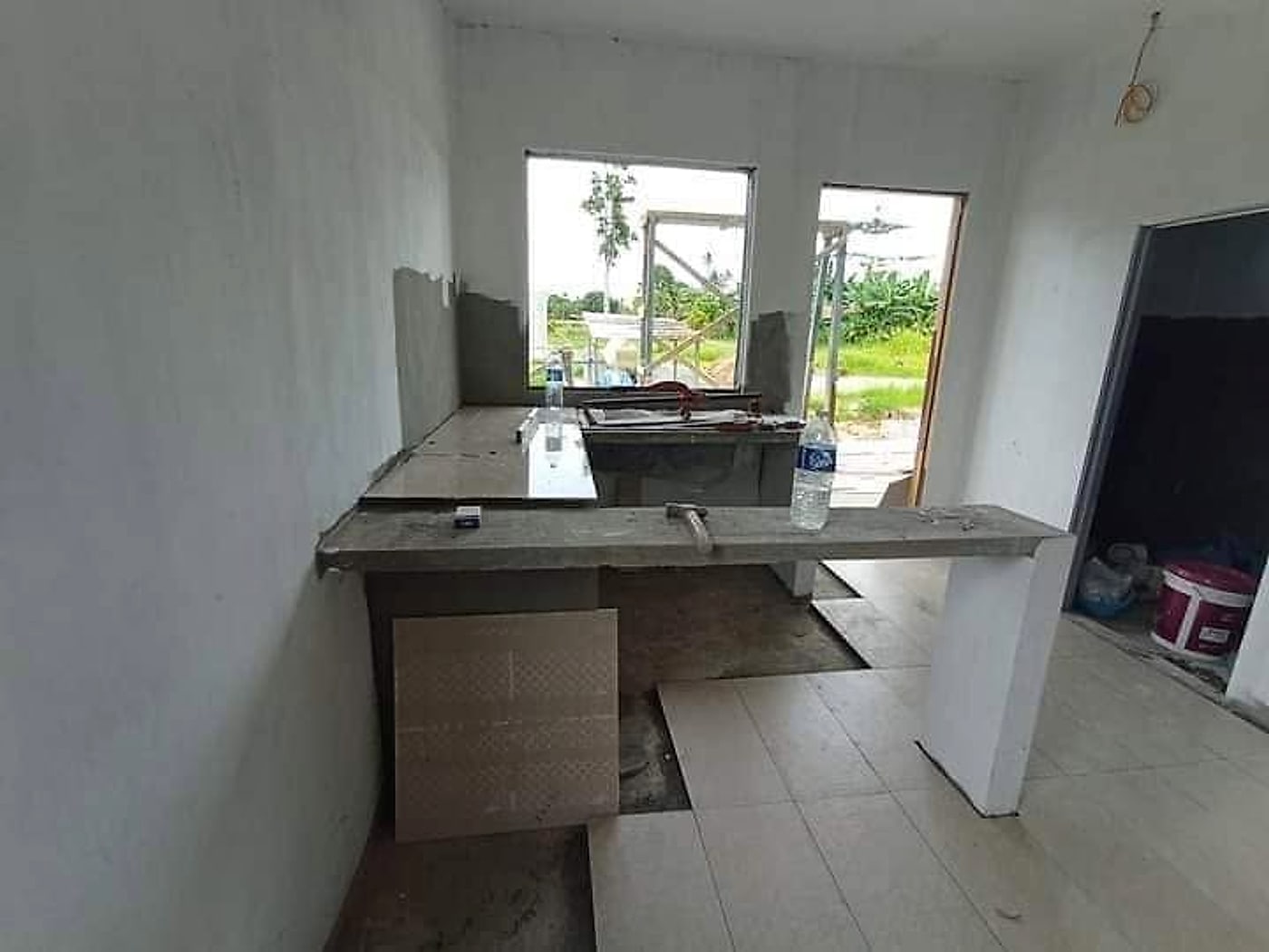 New concrete kitchen counter being tiled