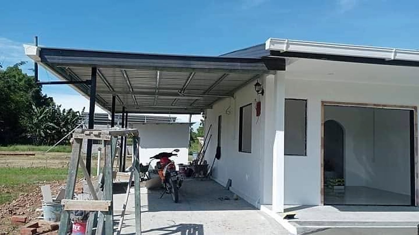 New metal-roofed car porch beside the house