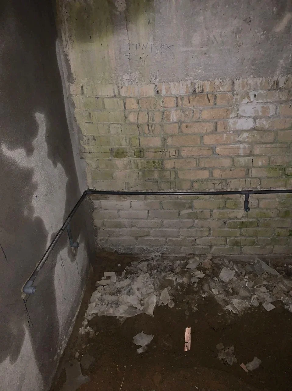 Water pipe run along the lower brick wall