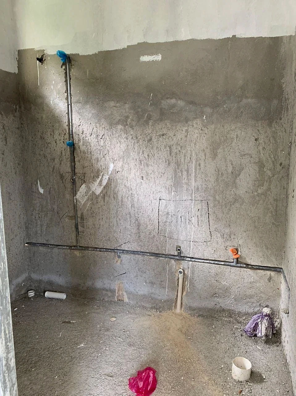 Bathroom wall with new water pipes and outlets