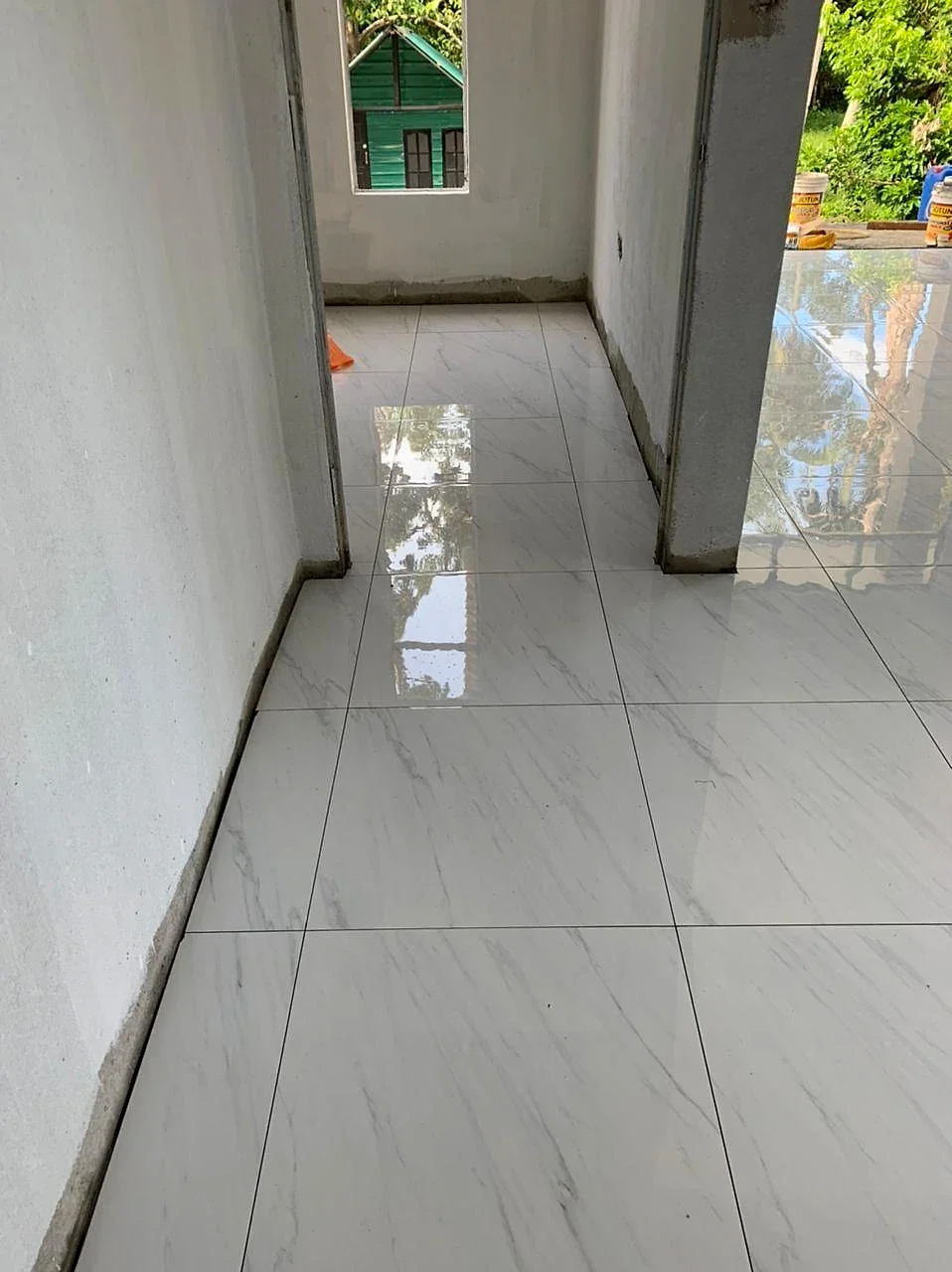 Glossy marble-look floor tiles laid in the hallway