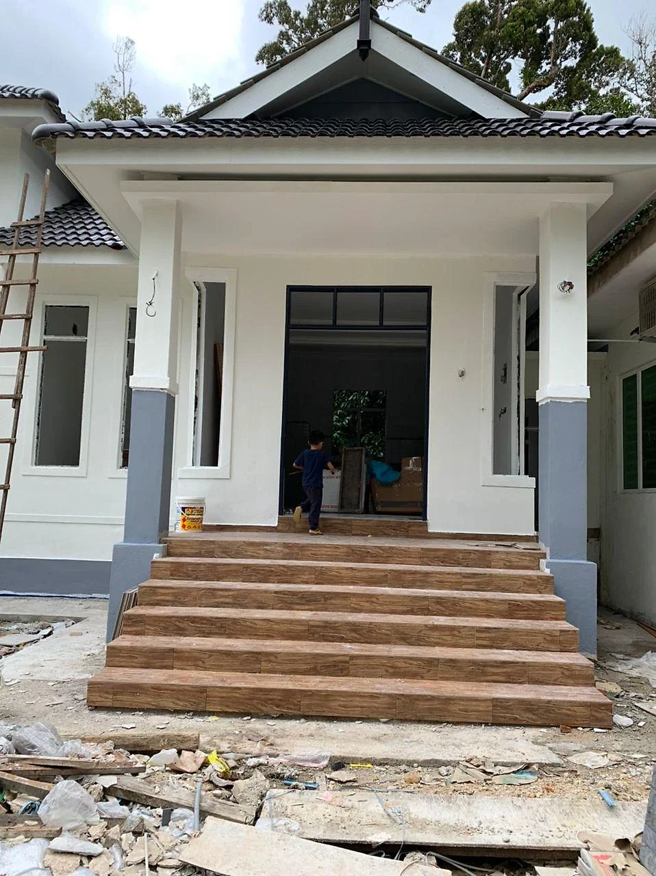 Finished porch with wood-look steps and white and grey columns