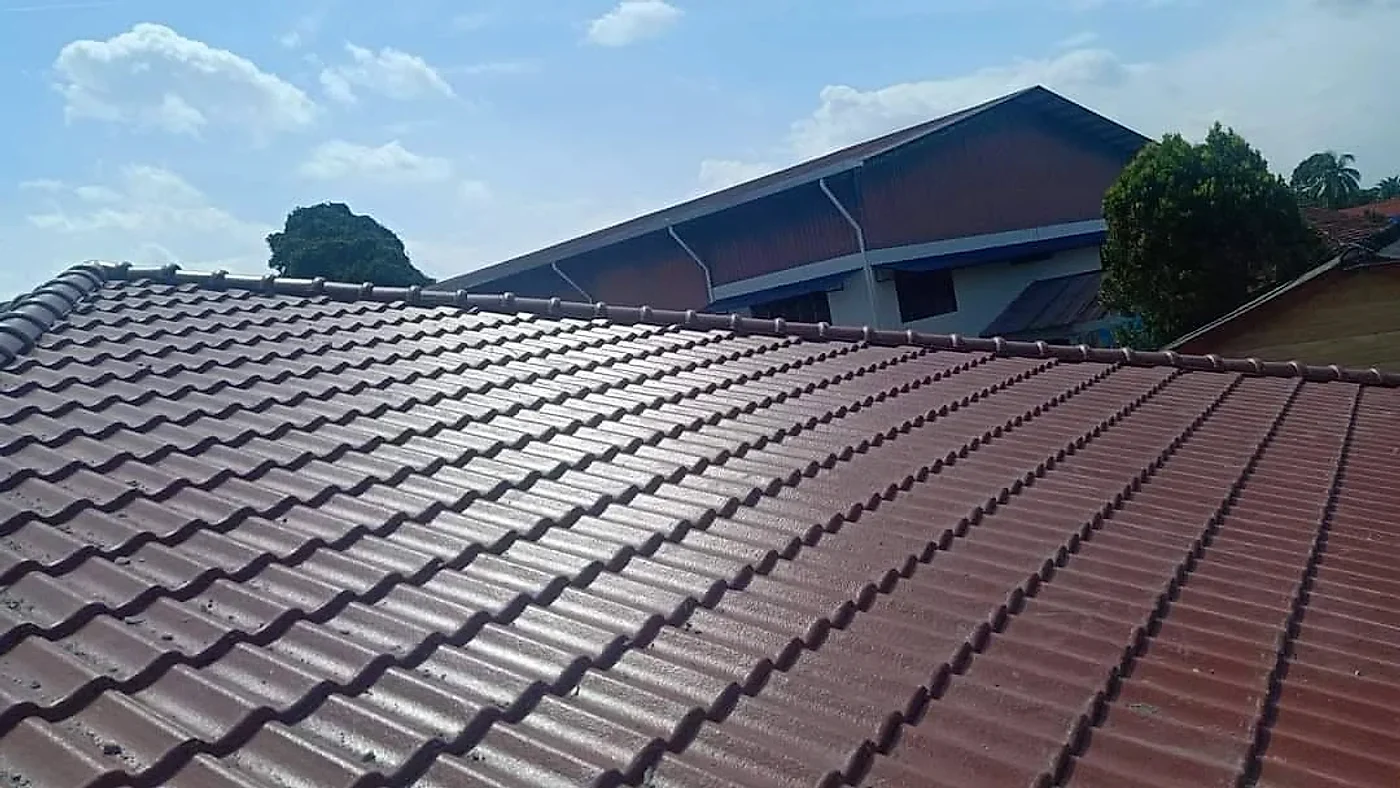 Even rows of new maroon roof tiles under the ridge
