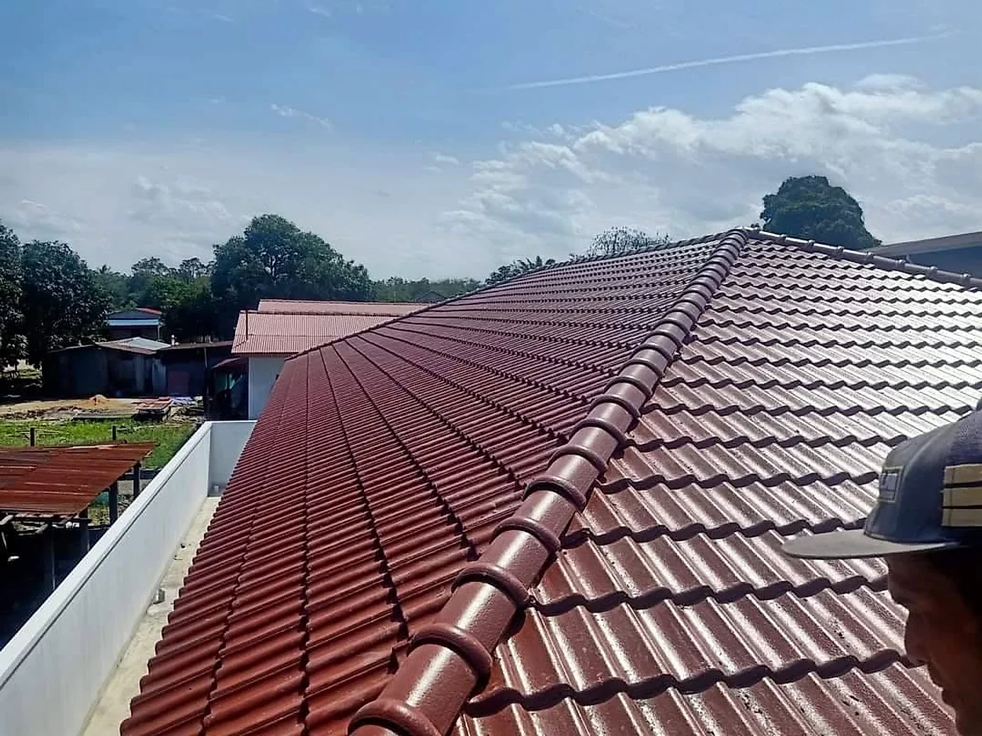 Close view of the new ridge capping on the maroon tiled roof