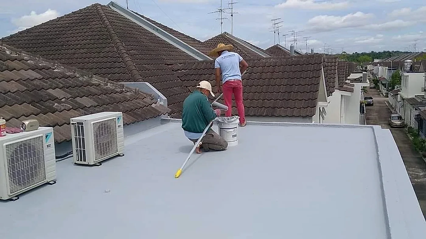 Final grey waterproof coat on a flat roof with air-conditioner units