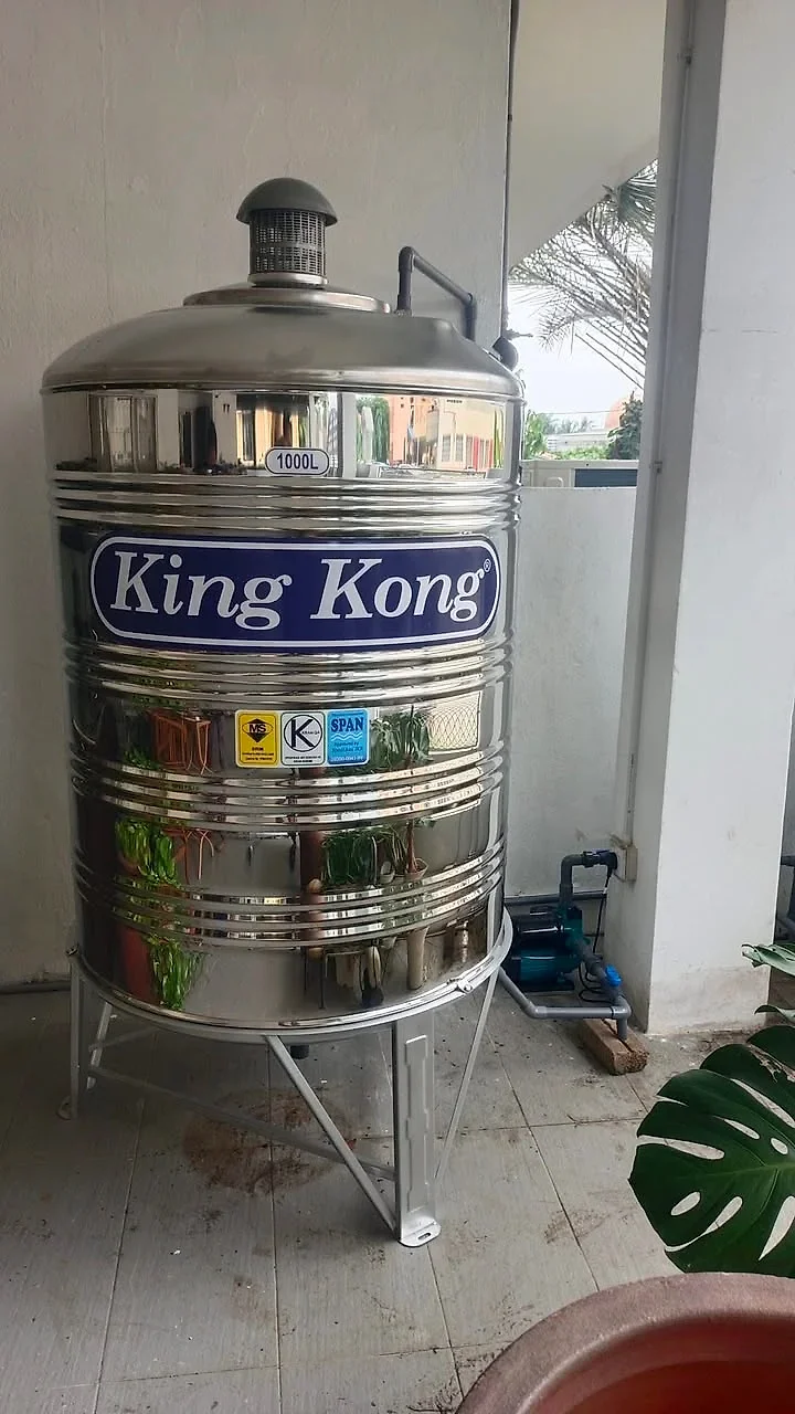 1000-litre stainless steel tank installed in a tiled porch